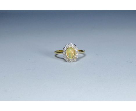 An oval opal and diamond cluster ring on a hallmarked 9ct gold shank, ring size 'O'