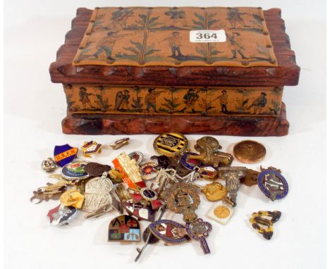 Various military and enamel badges in an old pine cigarette box 