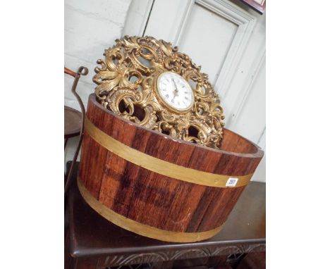 A barrel shaped planter and gilt wall clock   Clock is a Jaeger Electronic.In good condition. Cannot see any damage.