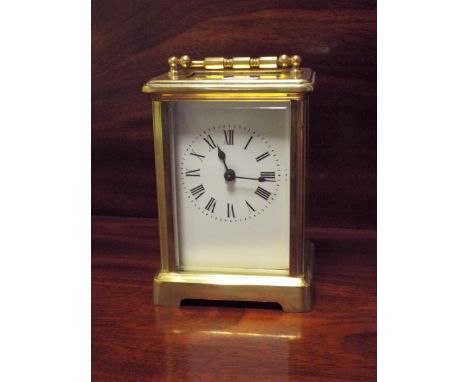 A French gilt brass carriage clock, 15cm tall with the handle up
