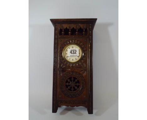 A Breton mantle clock set into a miniature wardrobe style case 