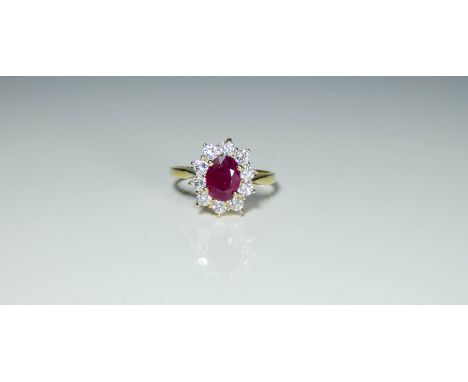 A large ruby and diamond oval cluster dress ring hallmarked 18ct yellow gold, Ring size N