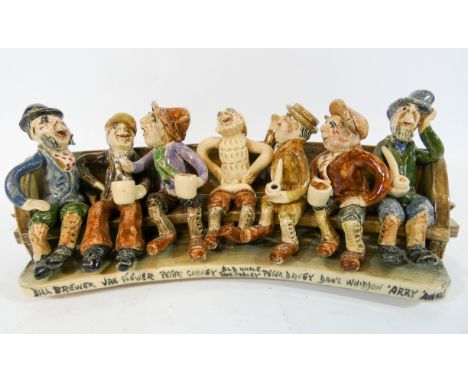 A Will Young Widdecombe Fair pottery group the figures seated on a long bench with their names underneath on the front of the