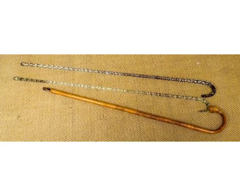 Two glass air twist walking canes and a carved bamboo stick 