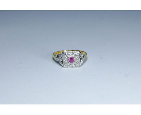 An 18ct gold ruby and diamond square design cluster ring with further diamonds to the shoulders, ring size O-P