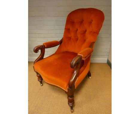 A Victorian mahogany framed terracotta upholstered elbow chair with button back 
