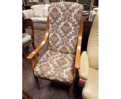 A high seat wood armed fireside chair in figured tapestry 