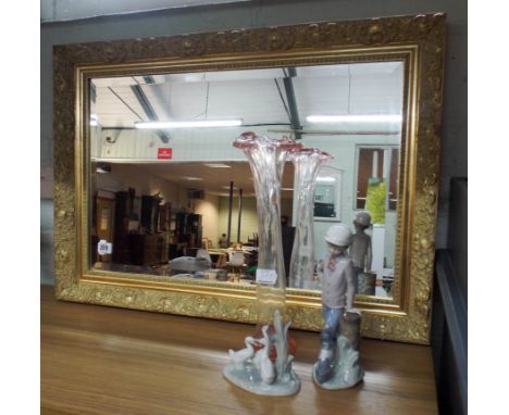 Bevelled wall mirror in decorative gilt frame, two Nao figures and a glass vase