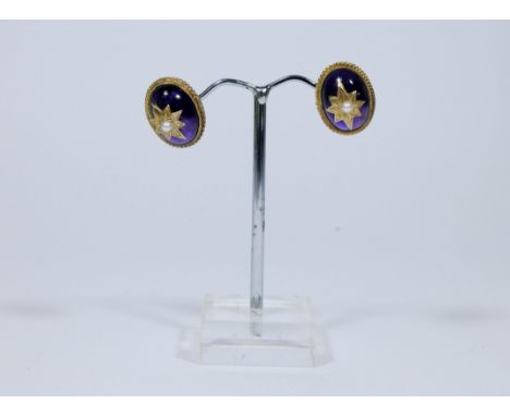 A pair of Victorian style cabochon amethyst ear studs, the oval amethyst decorated with a seed pearl star to the centre all s