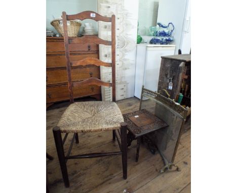 A ladder back chair with rush seat, a small carved occasional table and a brass fire screen 