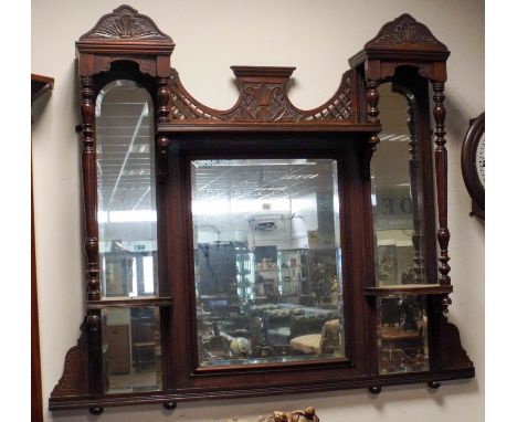 An Edwardian walnut framed over mantle mirror with trinket shelves 51" wide, 45" tall 