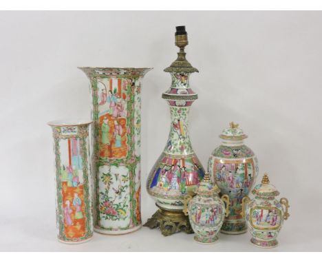 19th century and later Canton enamels, comprising two sleeve vases, a lamp, an inverted baluster vase and cover, and a pair o