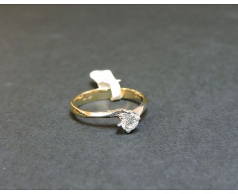 A 9ct yellow and white gold single stone diamond crossover ring