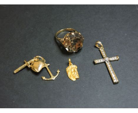 A single stone smokey quartz ring, stamped 9ct, a 9ct gold diamond set cross, a 9ct gold 'Faith Hope and Charity' charm, and 