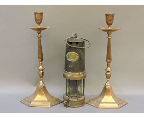 A Patterson GPO 'miner's' lamp, together with a pair of brass candlesticks, stamped TAR 1937