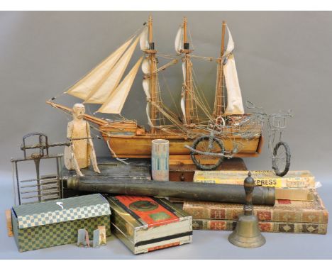 A wooden model ship, a book, a chess box, a small cabinet of drawers, a telescope, etc