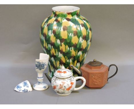 Yixing, a red ware body teapot, hexagonal and moulded with a dragon on a wan ground, the mouth replaced with silver, the hand