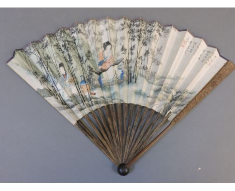 A Chinese paper leaf fan, painted with a lady playing a zither, inscribed to reverse and with chop marks, 47cm