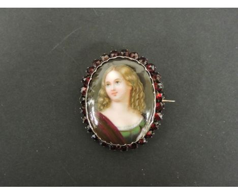 A painted ceramic Bohemian garnet brooch