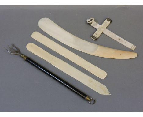 Three Victorian ivory page turners, largest 31cm, a telescopic toasting fork, and a Victorian ivory crucifix, damagedProvenan