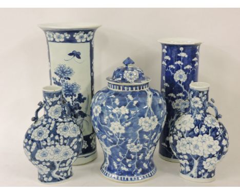 19th century blue and white ware, a cylindrical vase with chrysanthemums on a prunus blue ground, another with growing prunus