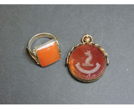 A 9ct gold swivel fob, and a cornelian Arts and Crafts ring