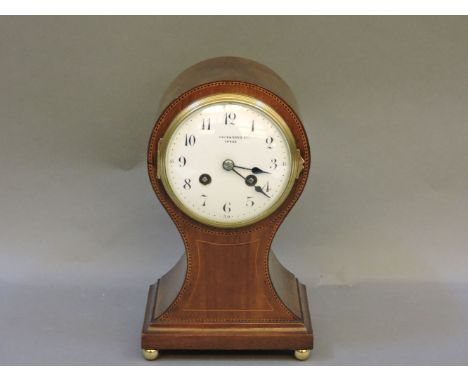 An Edwardian strung mahogany balloon mantel clock, with an enamel dial and French drum movement, 25cm highProvenance: from th