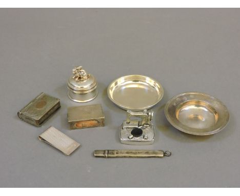 A collection of silver items, a Concorde napkin clip, Birmingham 1985, a miniature Armada dish, London 1969, a small cylindri