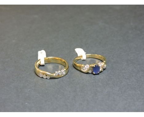 A 9ct gold sapphire ring, with diamond set wave shoulders, and a 9ct gold diamond set band ring