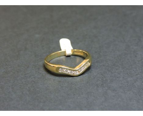 A 9ct gold channel set diamond wave head half eternity ring