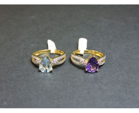An 18ct gold single stone aquamarine ring, with diamond set shoulders, and an 18ct gold single stone amethyst ring with diamo