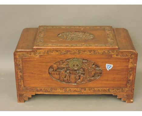 A Chinese camphor wood trunk, with carved panels, 91cm wide