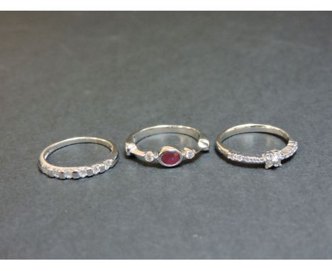 A stacking set of three rings, to include a diamond half hoop marked Pt 950, a diamond cluster ring with diamond shoulders ma