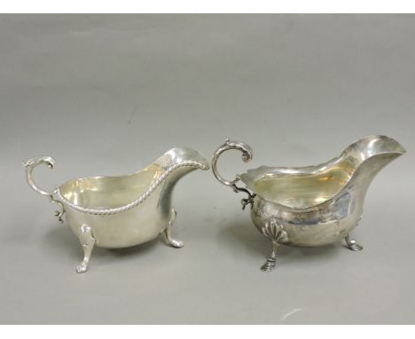 An early 20th century silver sauce boat, with foliated rim and leaf capped scroll handle, on three pad feet, Walker & Hall, S