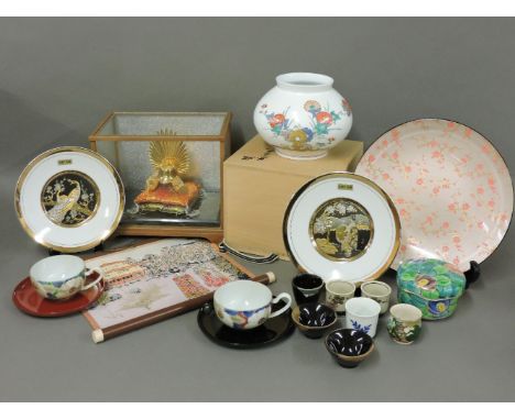 A collection of Japanese modern pottery, including two chopin plates, a Samurai helmet in display case, a 'Noh' wooden theatr