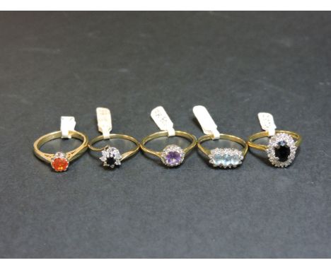 A 9ct gold single stone fire opal ring, an 18ct gold sapphire and diamond oval cluster ring, a 9ct gold amethyst and diamond 