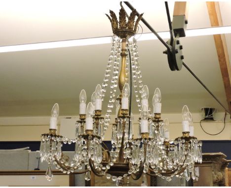 An early 20th century nine branch chandelier, with cut glass droplets and scrolling gilt branches