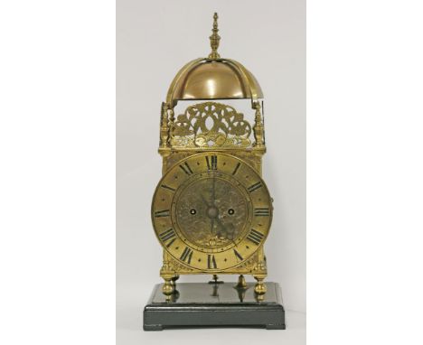 A brass 'lantern' clock, c.1900, double fusee, quarter striking on two gongs, on an ebonised square base, the dial inscribed 