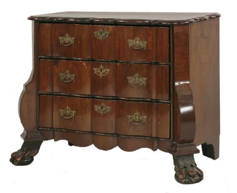 A Dutch walnut low commode,18th century, the shaped top over three long wavy drawers within columnar canted corners and paw f