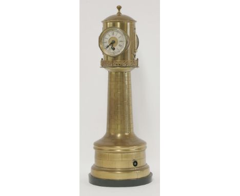 A Victorian brass lighthouse clock,the revolving top with clock, barometer and two thermometers on a tapering column, the bas