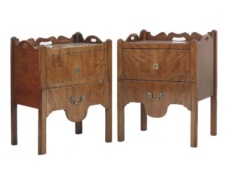 A matched pair of George III mahogany tray-top pot cupboards,the shaped three-quarter galleries over top hung cupboards, over