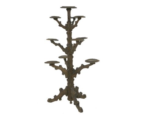 A Black Forest carved softwood plant stand,worked as a tree trunk with ten plant stands on a tripod base,147cm high