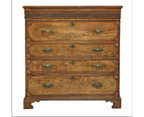 An elm chest,early 19th century, the top with a dentil and reeded frieze over a fitted secretaire drawer, and three further l