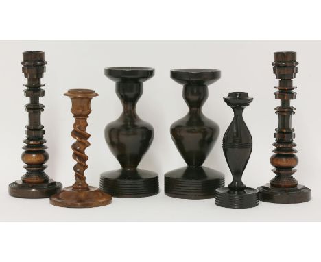 Two pairs of treen candlesticks,the first pair in lignum vitae, with ornamental engine turned decoration and bases that unscr