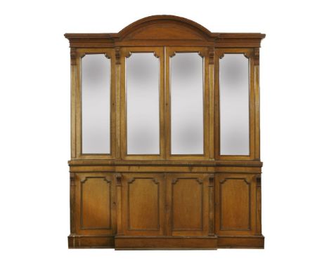 A Victorian light oak breakfront bookcasewith an arched cornice and glazed upper doors, the base with solid panelled doors,22