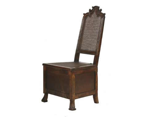 An Anglo-Dutch walnut commode,late 17th or early 18th century, having an arched and scroll decorated top rail, a bergŠre back