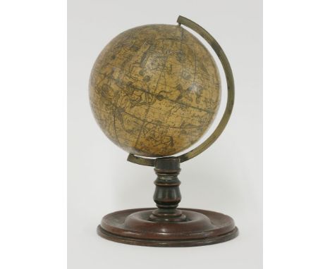 A celestial table globe, 19th century, paper on wood, printed with named signs of the zodiac and scientific instruments, with