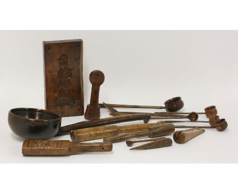A collection of fifteen 18th and 19th century treen items,a large serving ladle, 40cm, two gingerbread moulds,one of a Georgi