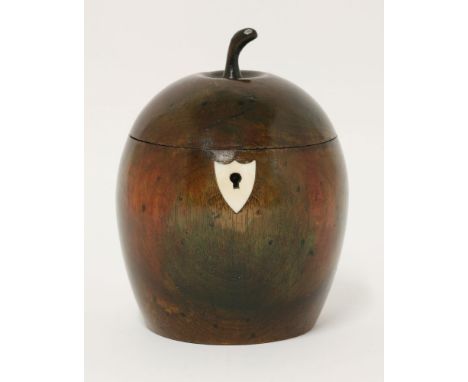 A fruitwood tea caddy,19th century and later, of apple form, now with ivory shield-shaped escutcheon, signs of original colou