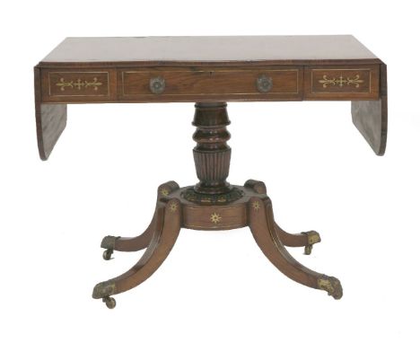 A Regency inlaid rosewood sofa table,with brass inlay and frieze drawer, on a turned column and four sabre legs with brass li